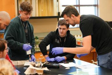 Chris Huber helps students test well water